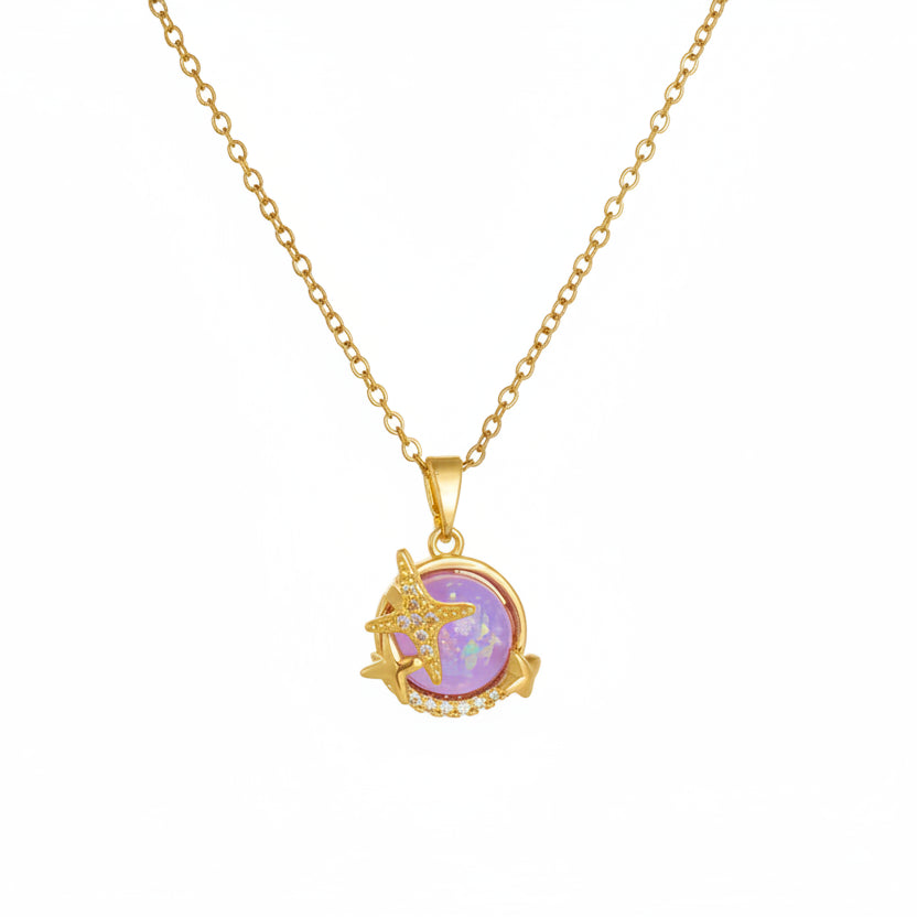 Gold necklace with a pink pendant on a white background