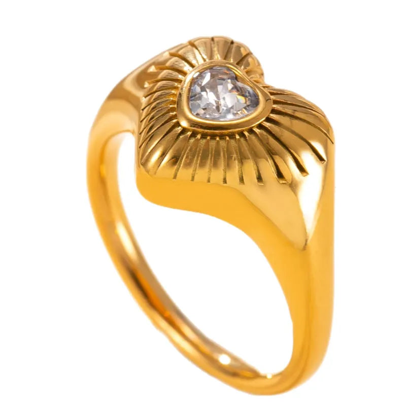 Gold ring with a heart-shaped diamond on a white background