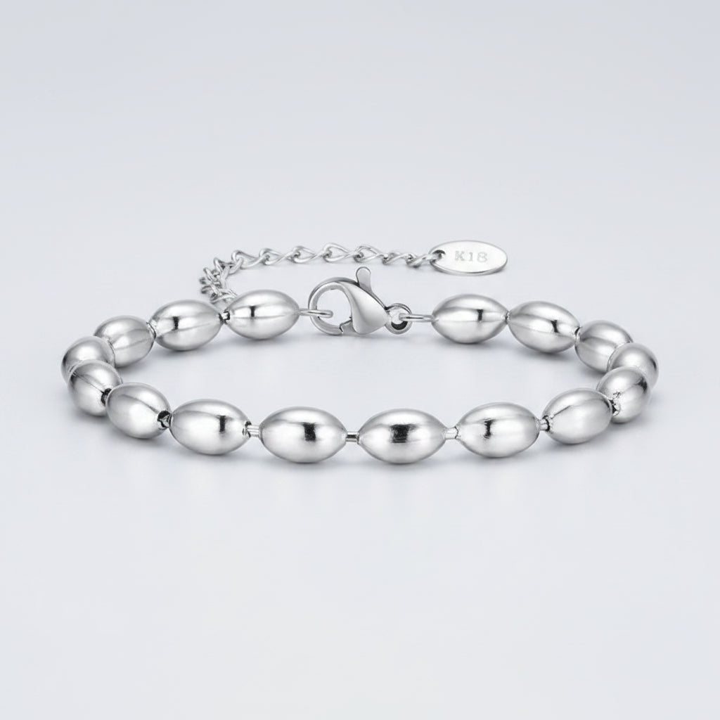 Silver bracelet with oval beads on a white background, featuring KON brand.