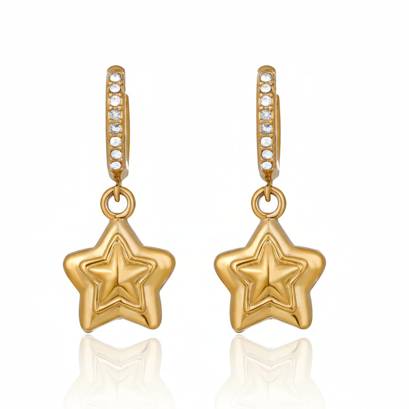 Gold star-shaped earrings on a white background