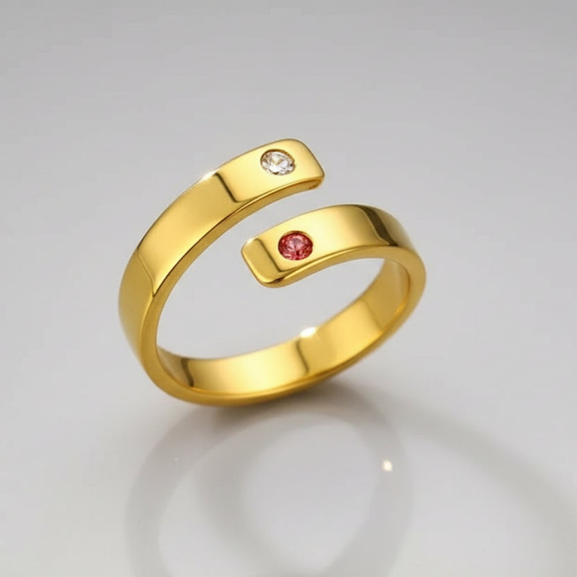 Gold ring with embedded gemstones on a textured background