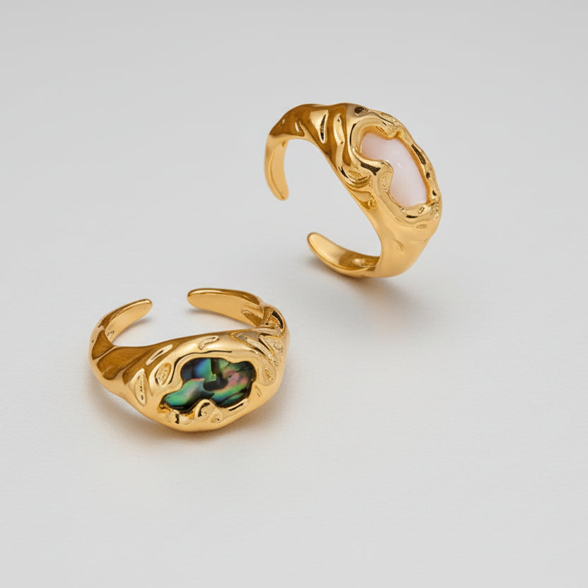 Gold Rings with Abalone Shell on a light background