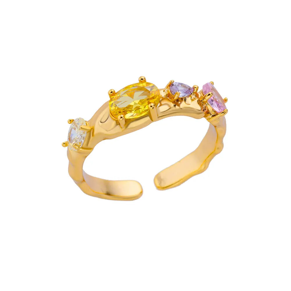 Gold ring with multicolored gemstones on a white background