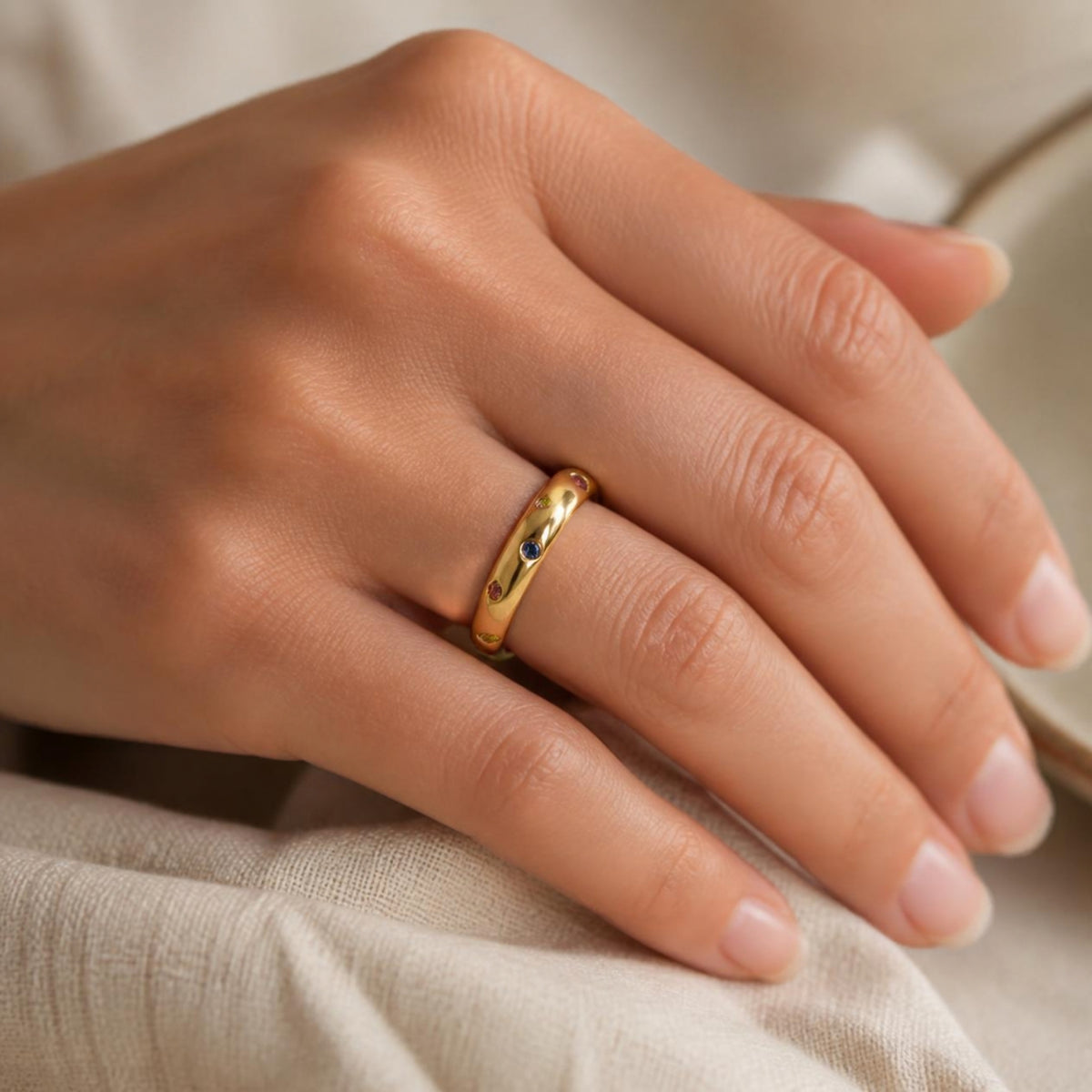Polka Dot Ring worn on finger, showing the multicoloured gemstones dotted around the band