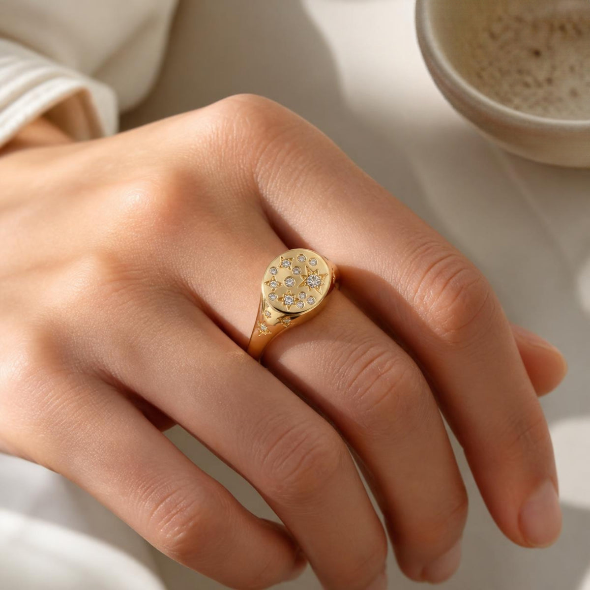 Bright Star Ring worn on finger, showing the constellation pattern on the signet face