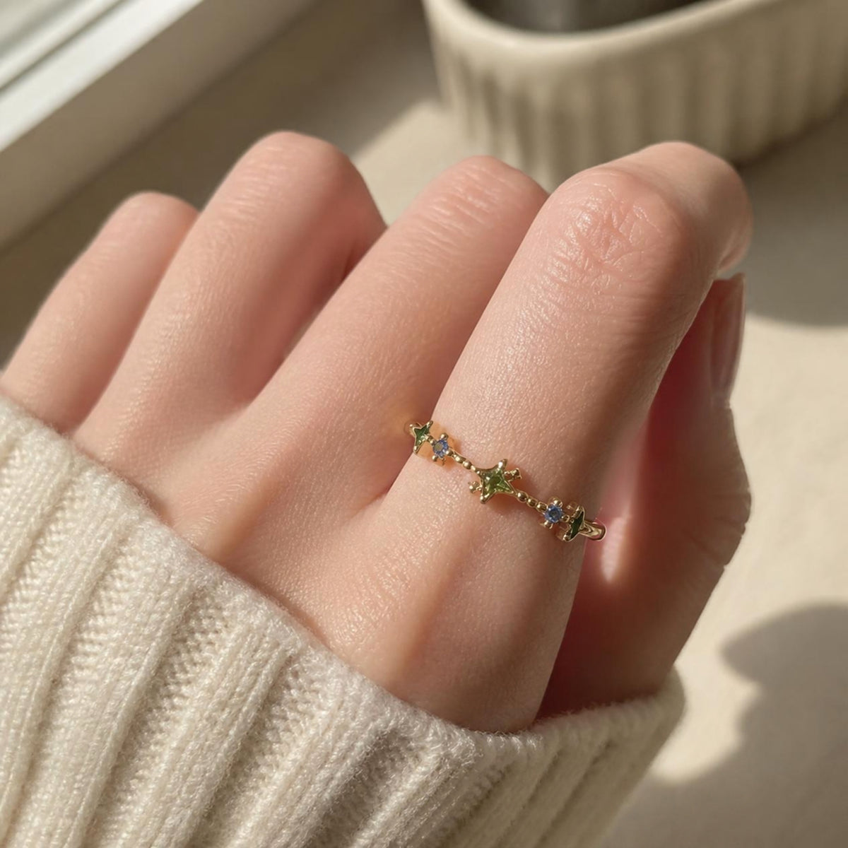 Twinkle Ring worn on finger, showing the star and teardrop-shaped zircon gemstones