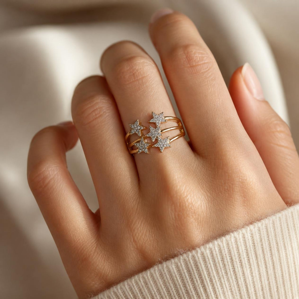 Gold star ring worn on a hand