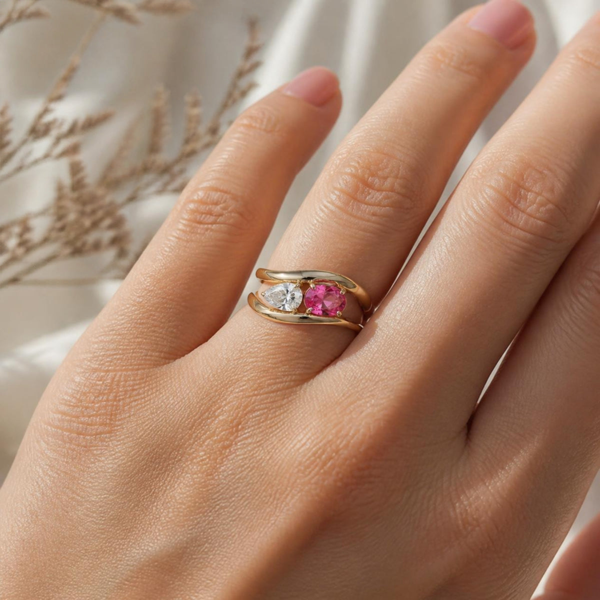 Fusion Ring worn on finger, showing the pink and clear stones on the bypass band