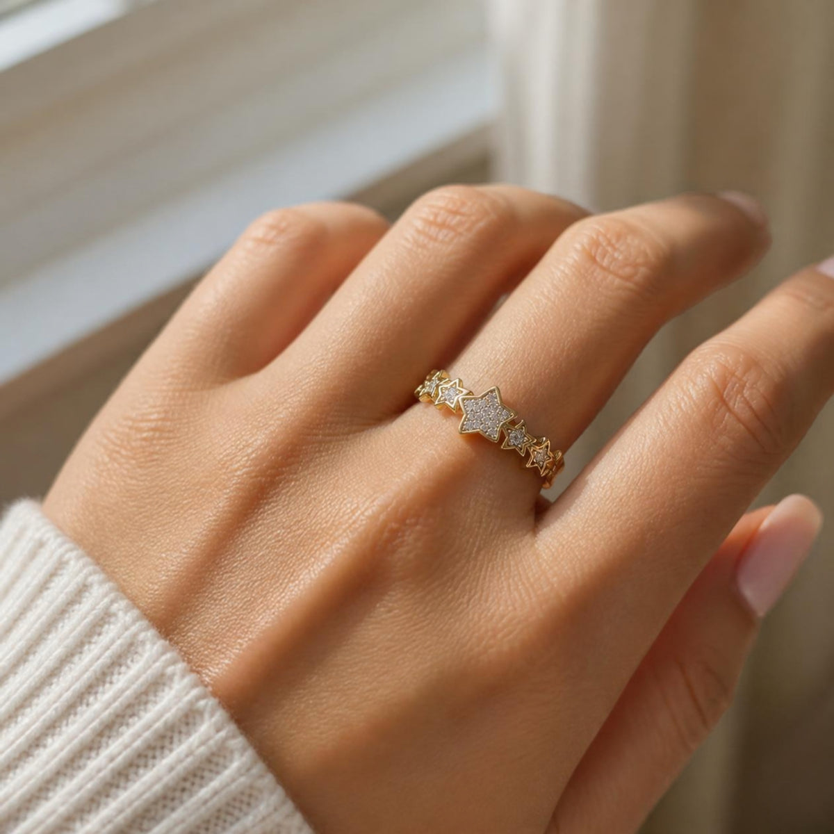 Gold star ring worn on a hand
