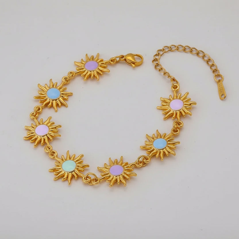Gold bracelet with sunflower designs on a beige background