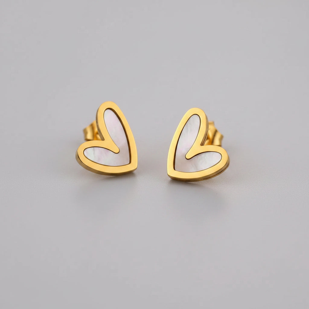 Gold heart-shaped earrings on a light background
