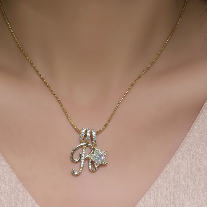 Necklace with a letter 'R' pendant on a mannequin wearing a white lace top.