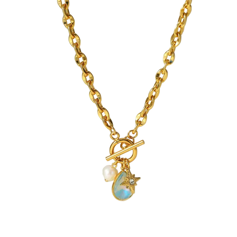 Gold necklace with charms on a soft background