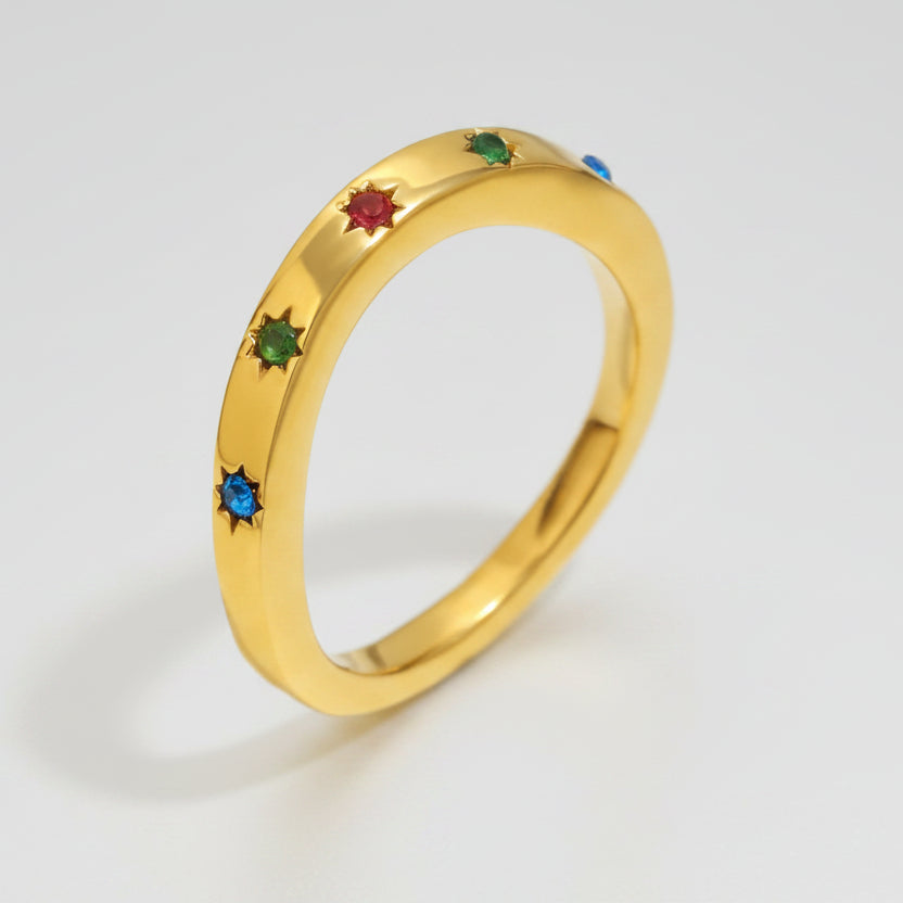 Gold ring with colored stones and measurements on a white background