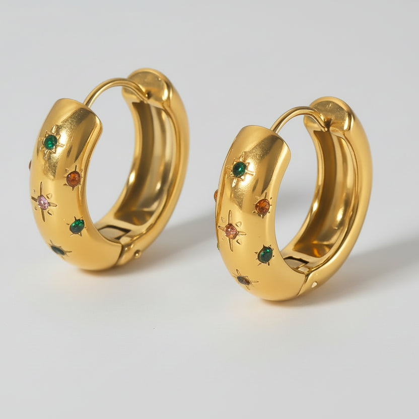 Gold hoop earrings with multicoloured gemstones.