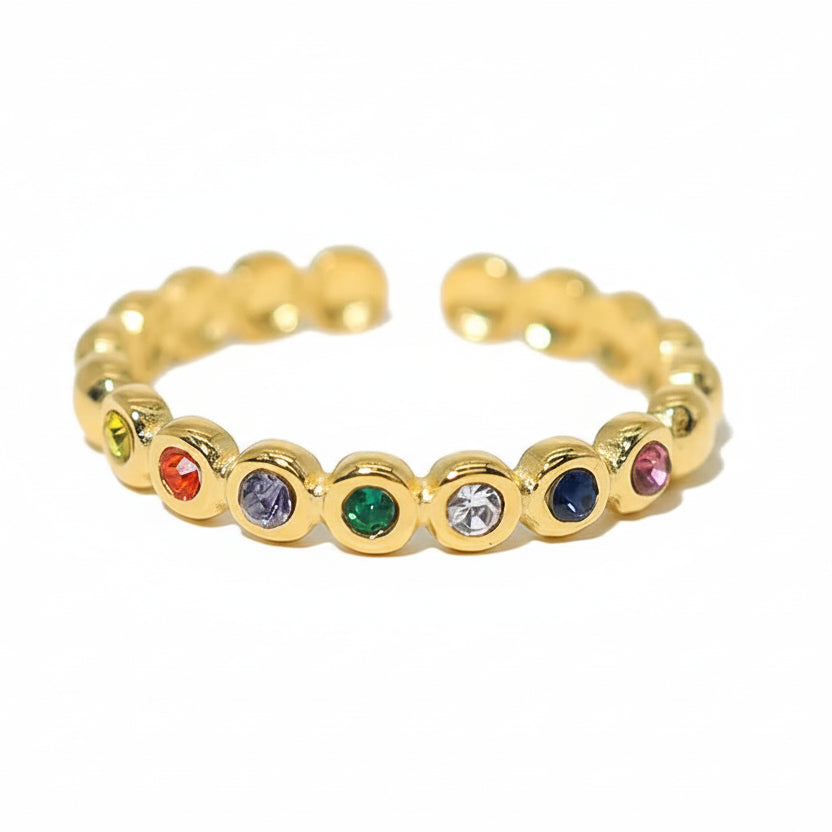 Gold ring with colored stones and measurements on a white background
