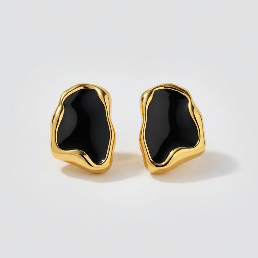 Gold earrings with black stones.
