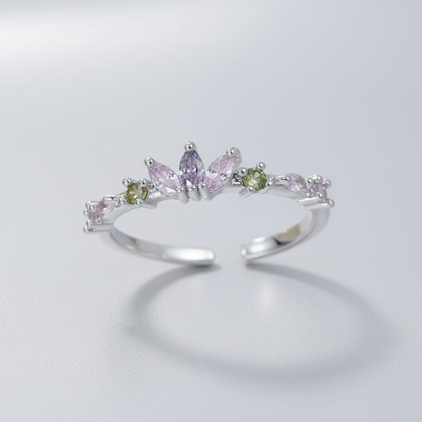 Silver ring with colorful gemstones on a white background