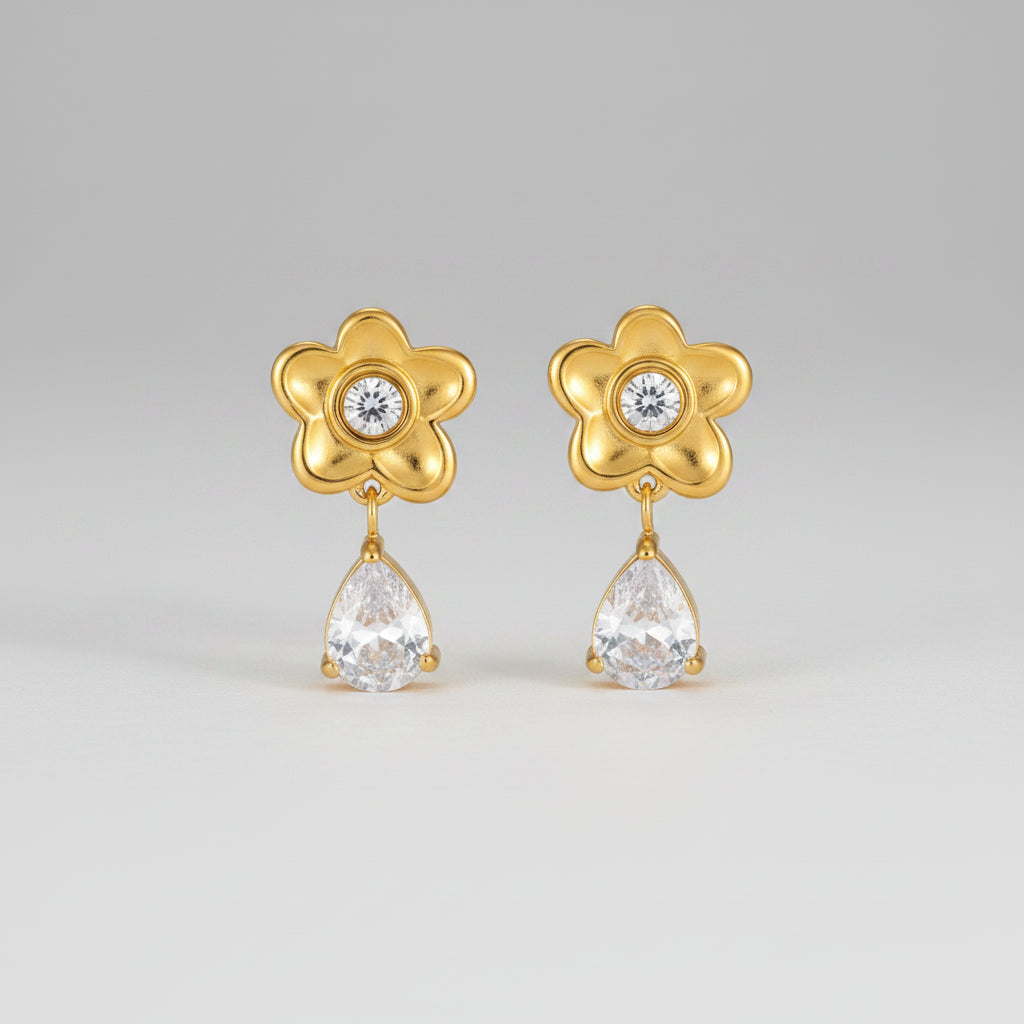 Gold flower-shaped earrings with teardrop-shaped crystals, shown with measurements and weight on a white background.