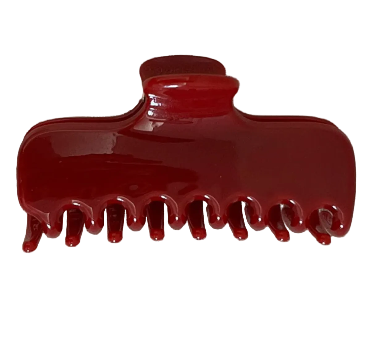 A glossy dark red hair claw clip placed on a textured beige fabric background.