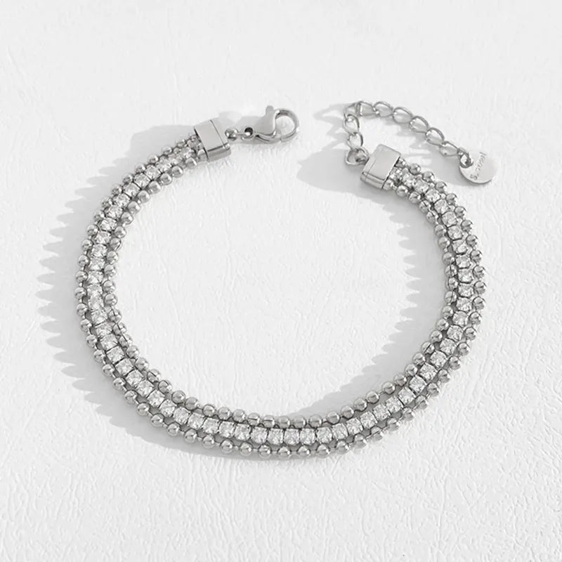 Silver bracelet with clear stones on a white background