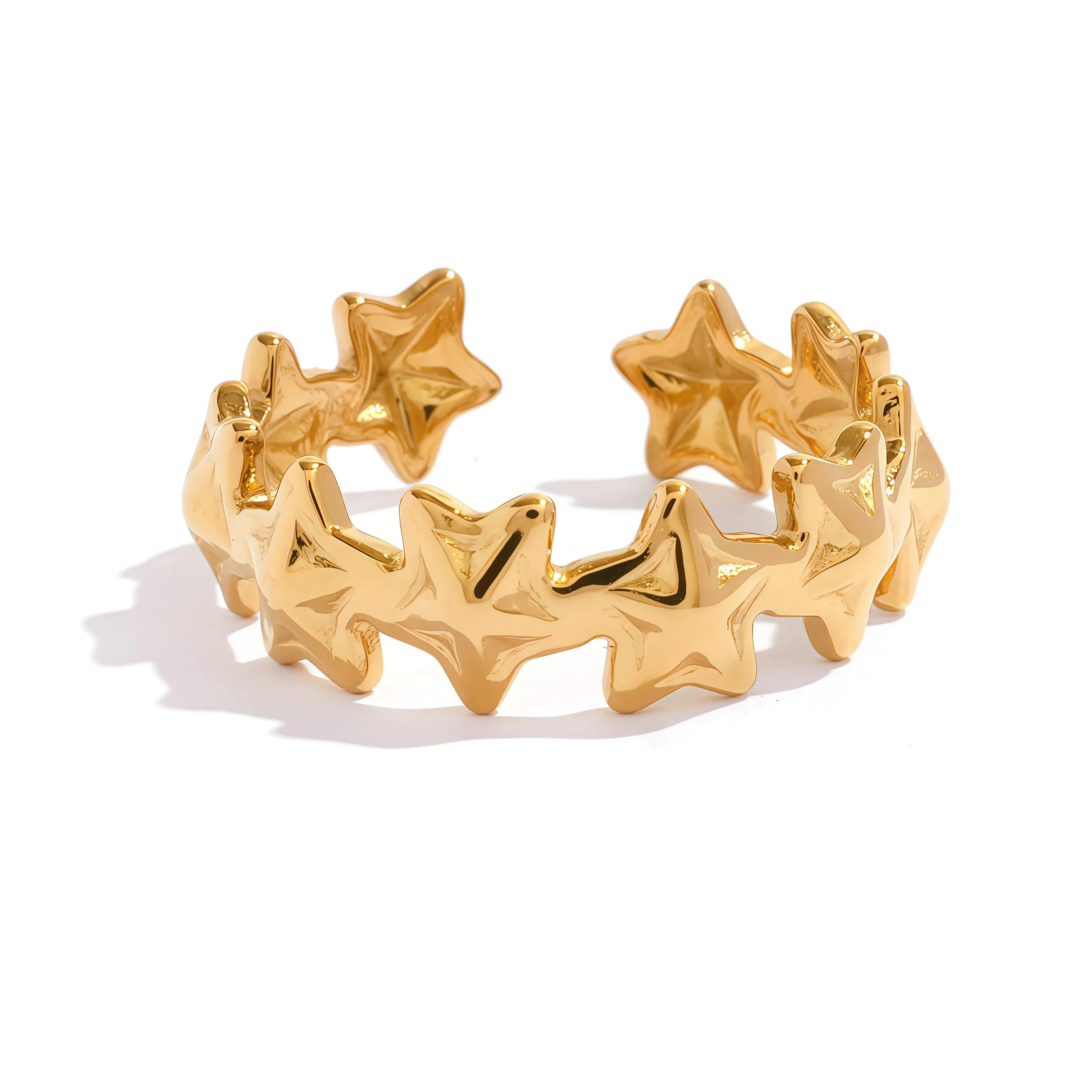 Gold star-shaped cuff bracelet on a white background