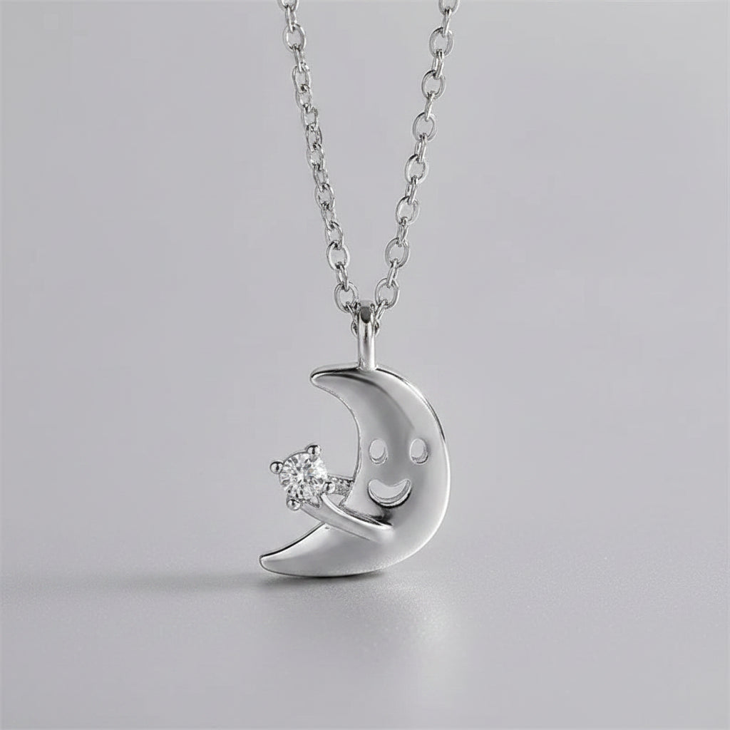 Silver necklace with a crescent moon pendant featuring a diamond on a beige background