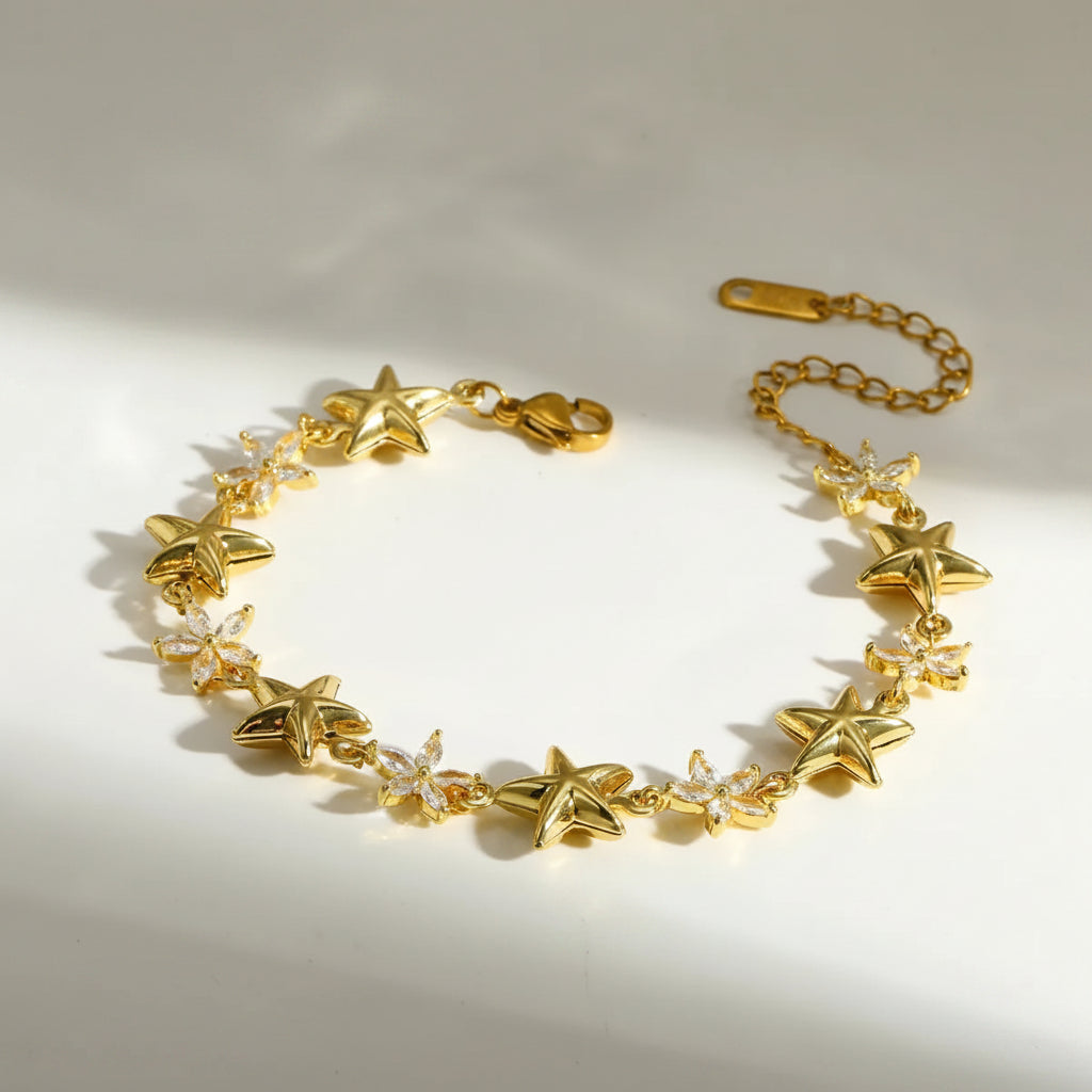 Gold bracelet with star-shaped charms on a light background